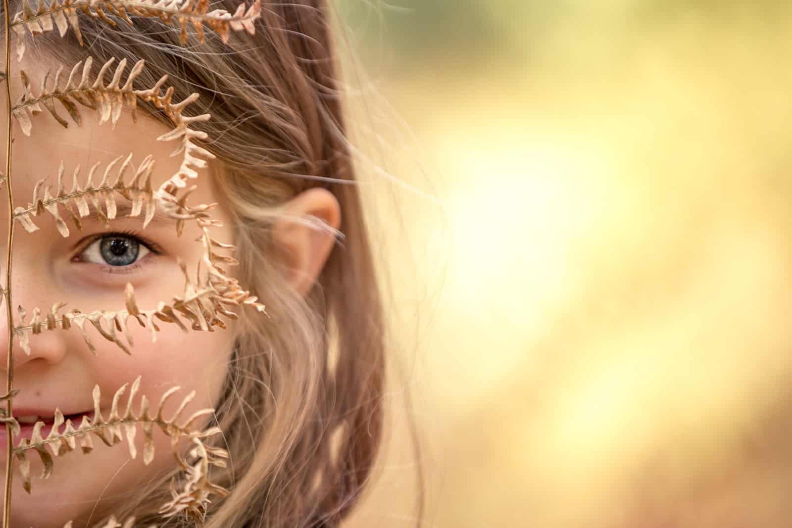 Partial face portrait of a girl in the autumn colours at Ashridge