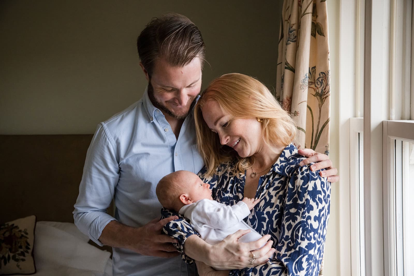 Parents smile at their newborn
