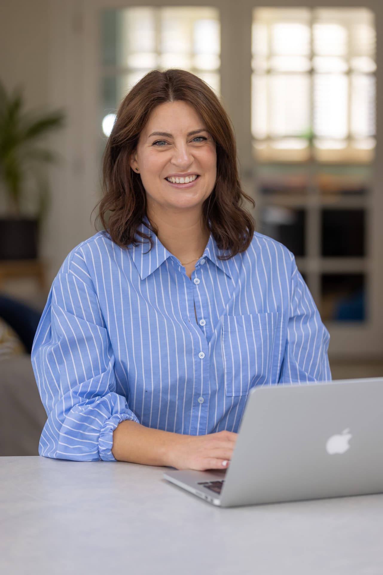 Woman working at her desk during a brand photography session in Berkhamsted