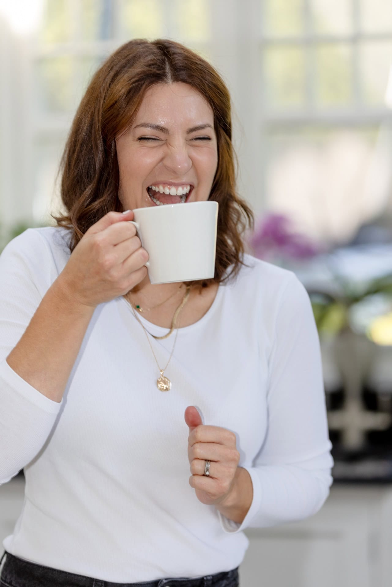 Woman laughs, relaxed, during a small business photoshoot