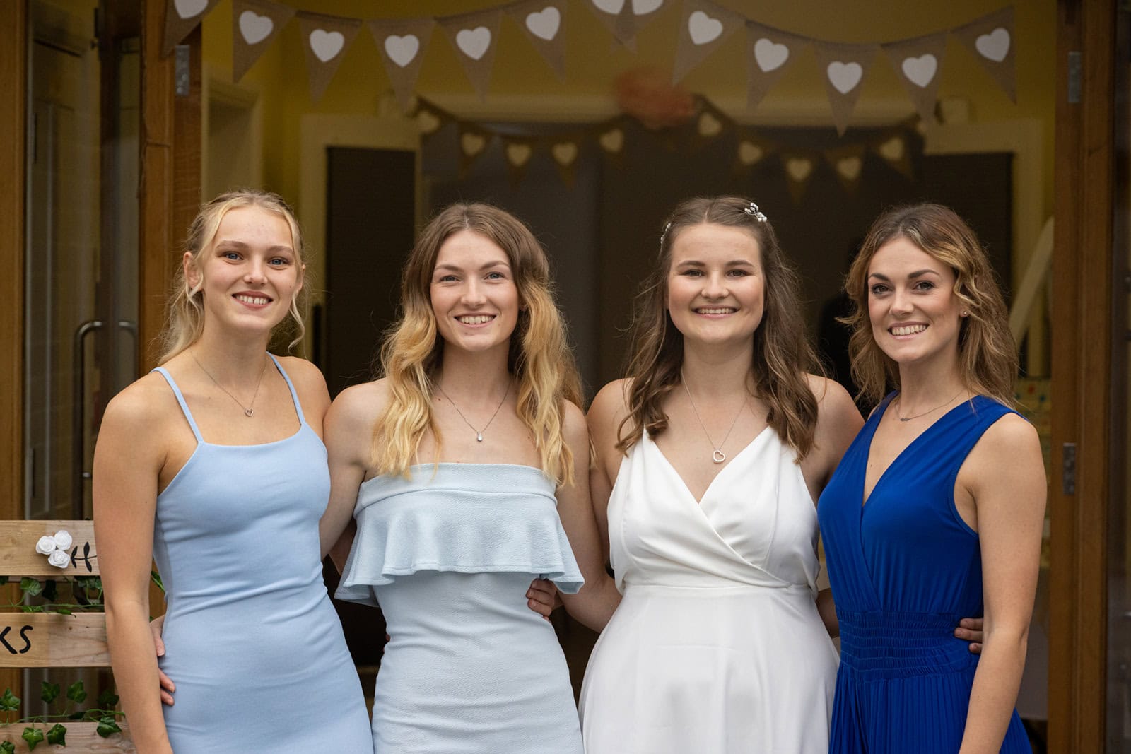 A bride stands with her bridesmaids at a weddign in Harpenden