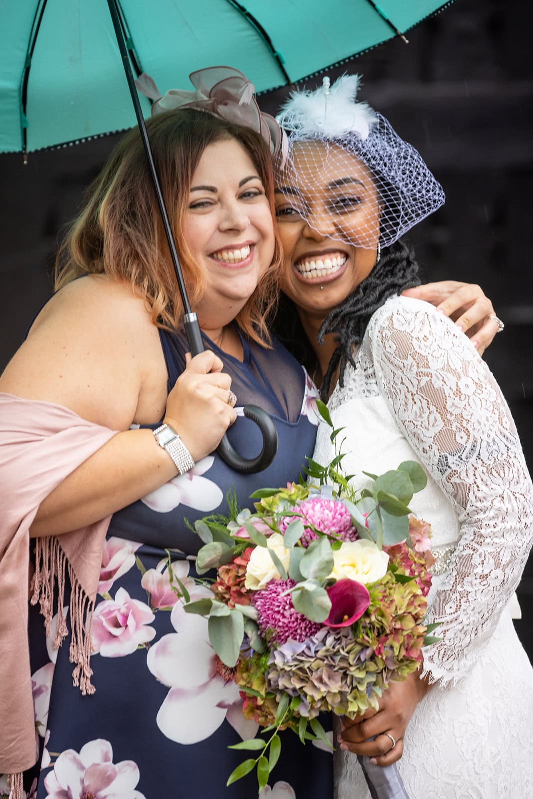 A bride and her friend share a excited hug following her wedding at St Albans registry office