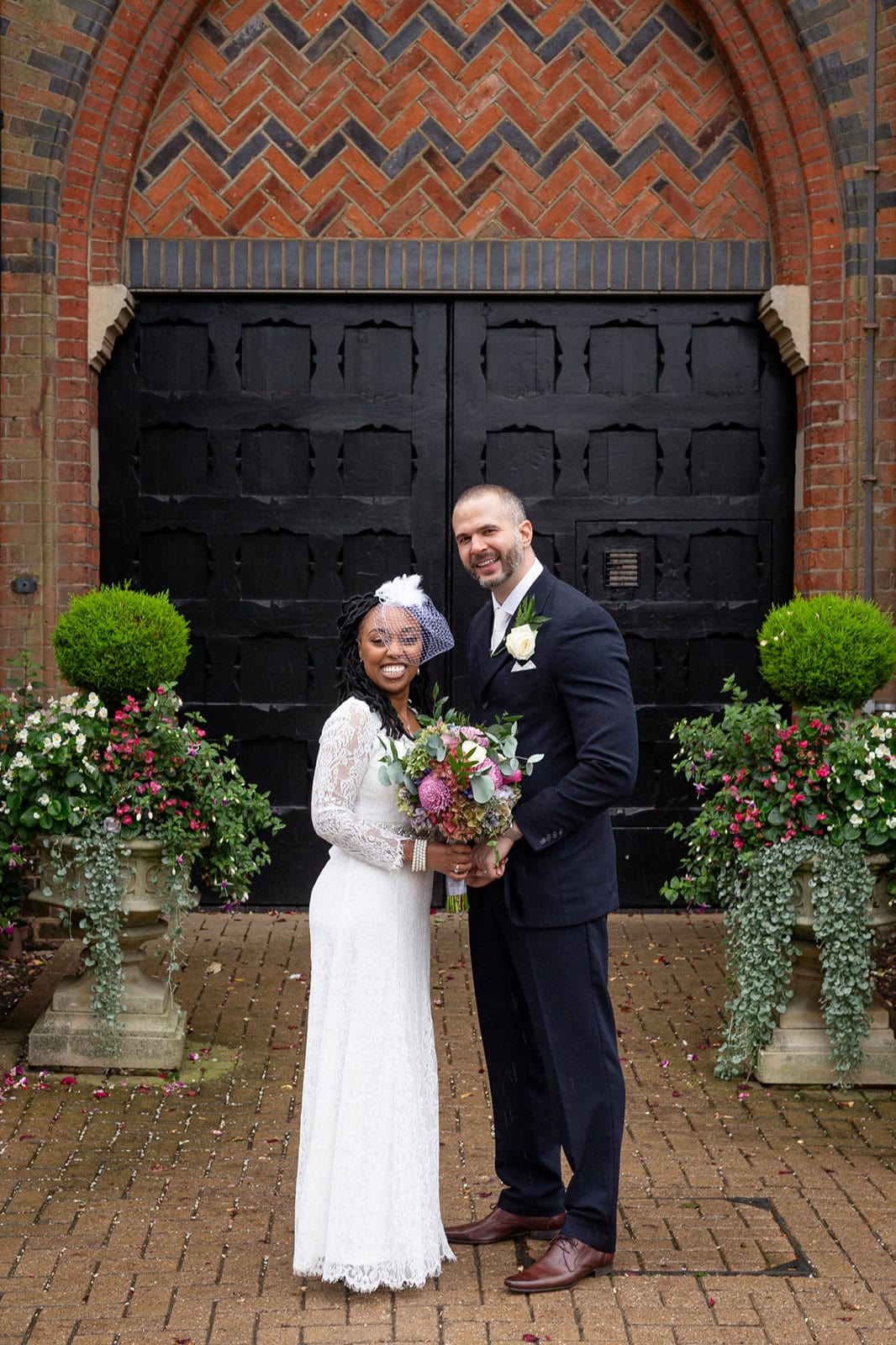 A bride and groom pose outside St Albans registry office