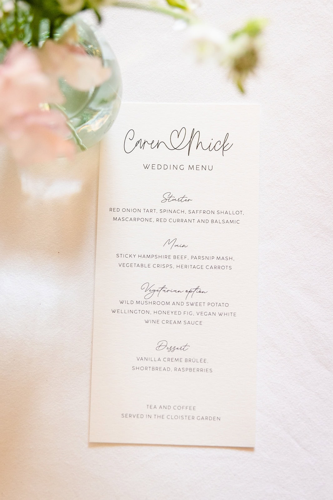 Detail photographs from a wedding day - this one is the menu from the wedding breakfast framed by florals from the day