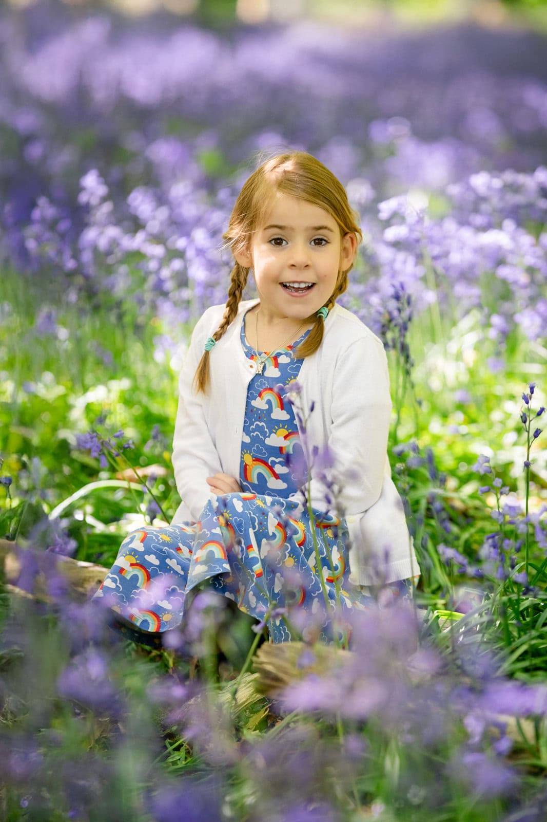 A girl smiles during a fun bluebell photoshoot near Hemel