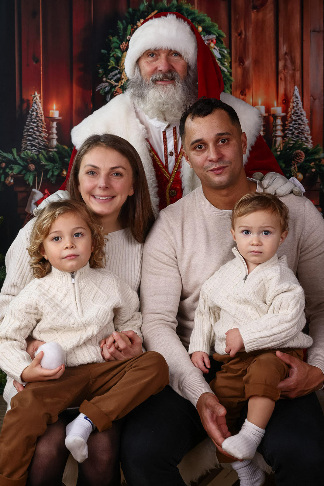 Family smiles for a photograph while meeting Father Christmas near Tring