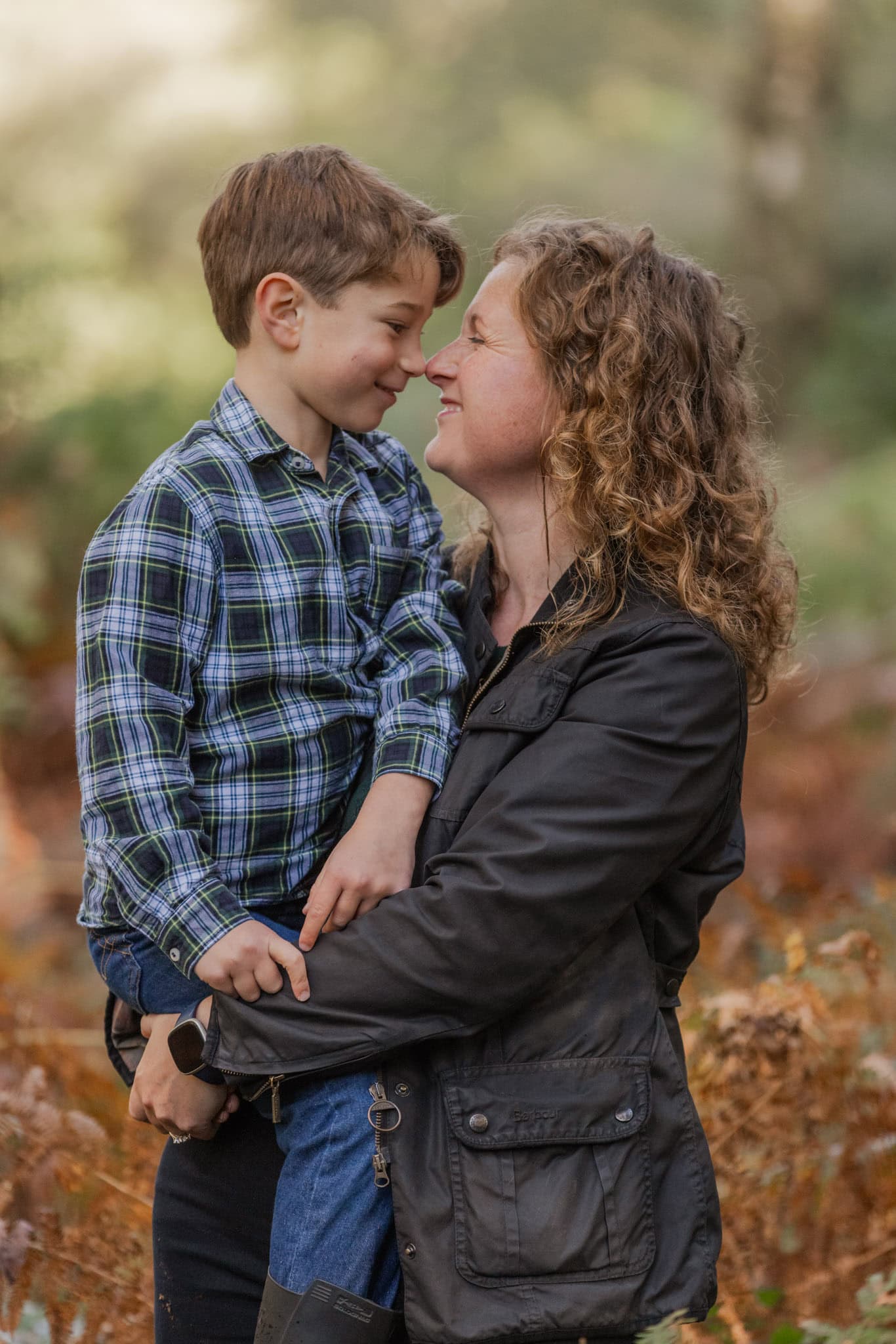 A mum and her son tickle noses during a fun photoshoot bear Hemel