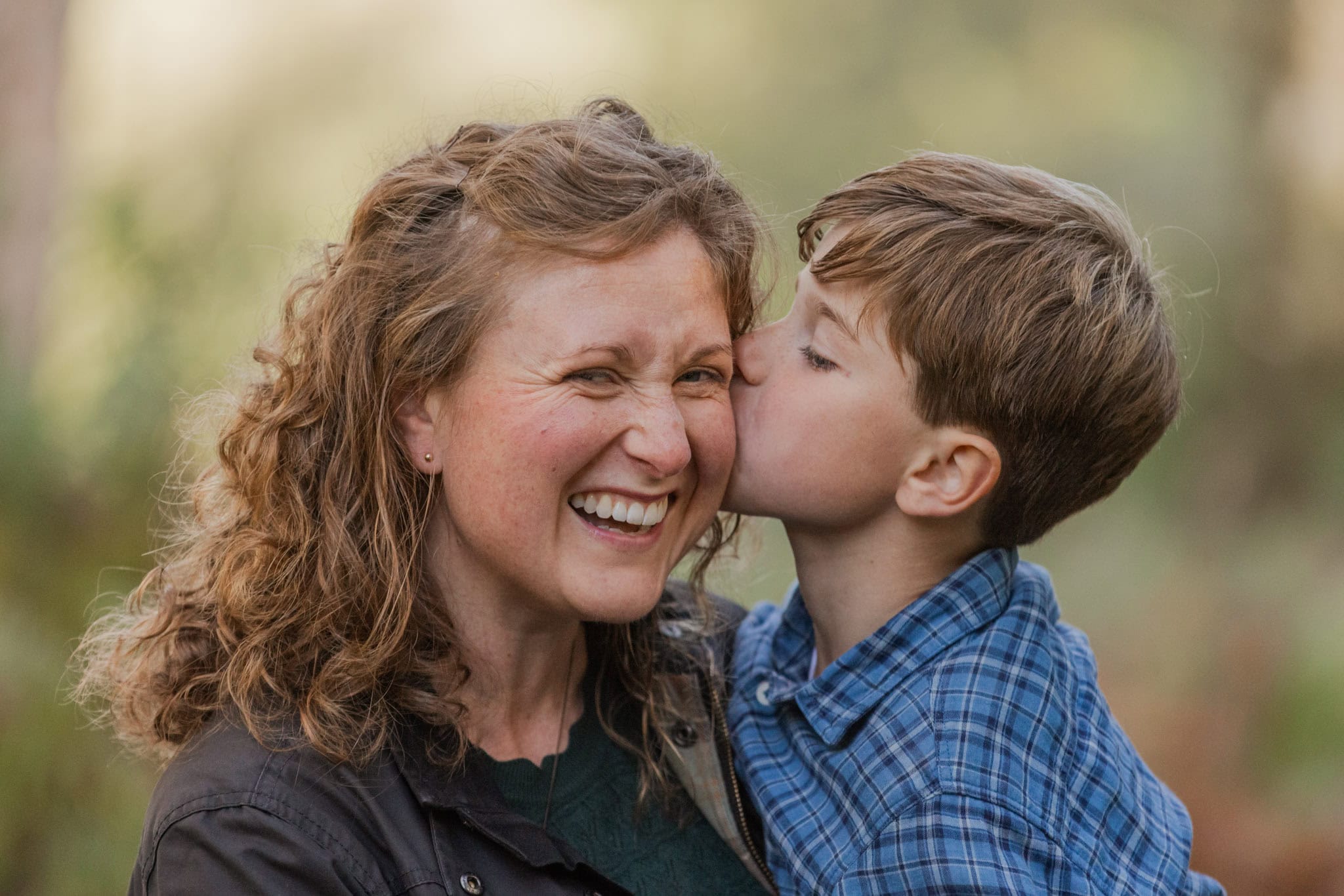 A boy kisses his mum during a fun autumn photoshoot in hertfordshire